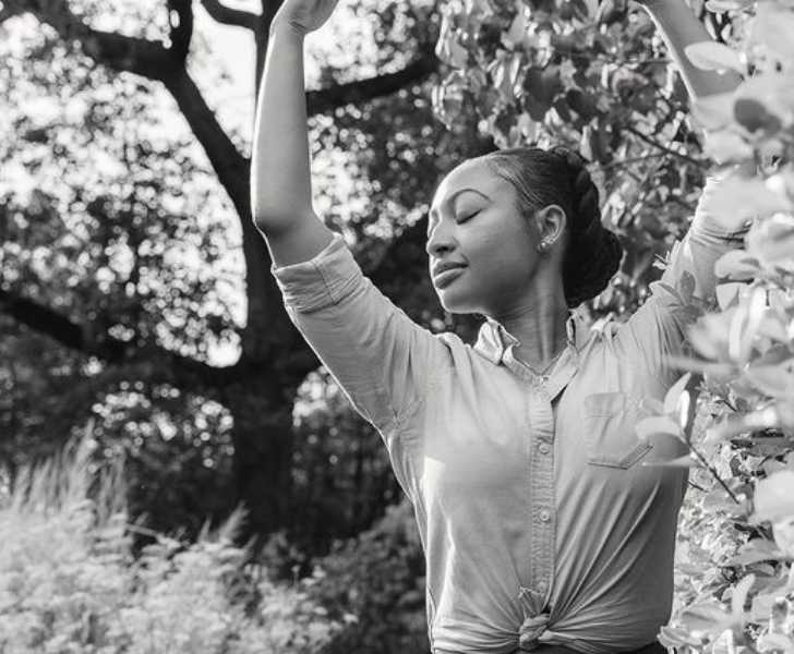 Picture Of Aleisha Allen posing for a photo with beautiful background in black and white theme.